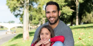 Father and daughter smile at camera width 960
