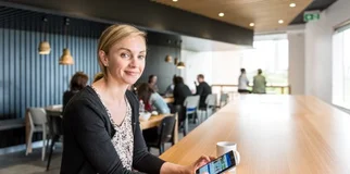 Woman smiles at camera in cafeteria photo max 800x600