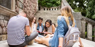 group of teenagers sitting in circle on steps
