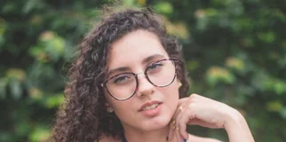 Young woman with glasses looking in camera