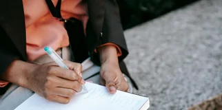 Person writing in notebook
