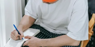 A person writing on a notepad