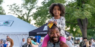Man with daughter on shoulders