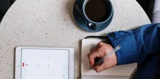 Person with tablet calendar and notepad