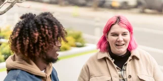 two friends having coffee smiling