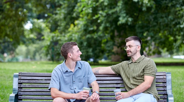 two boys sitting on park bench