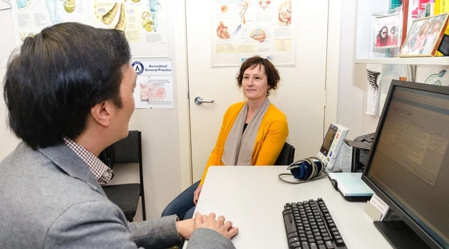 Woman sits in doctors clinic width 960